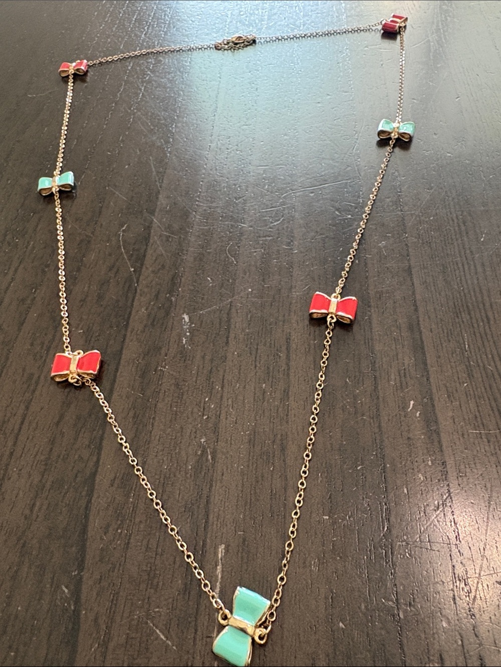 Gold-Tone Necklace with Red and Turquoise Bow Charms